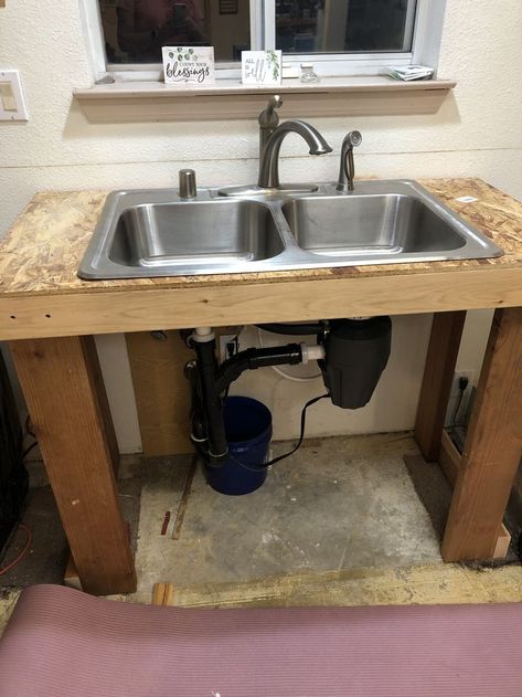 Here is the temporary kitchen sink stand my son in law and husband built, following a water leak that damaged all our cabinets and flooring. What a lifesaver this will be while we wait a few months for cabinets and the kitchen rebuild! Furniture Kitchen Sink Base, Freestanding Sink Kitchen, How To Build A Kitchen Sink Base Cabinet, Stand Alone Utlity Sink And Side Shelves, Kitchen Sink Stand, Free Standing Kitchen Sink, Life Savers, Kitchen Sink, Flooring