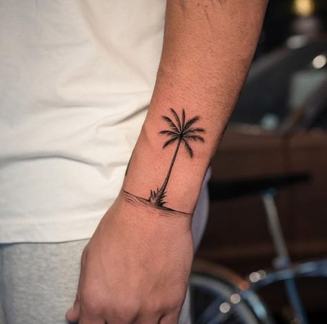 23 Palm Tree Tattoos: A Symbol of Paradise and Relaxation - Body Artifact Palm Tattoo Men, Beach Tattoo For Men, Plant Tattoo Men, Palm Tree Tattoo Men, Mens Tattoos Ideas Forearm, Small Palm Tree Tattoo, Palm Tree Tattoo Ideas, Tattoo Palm Tree, Vacation Tattoos