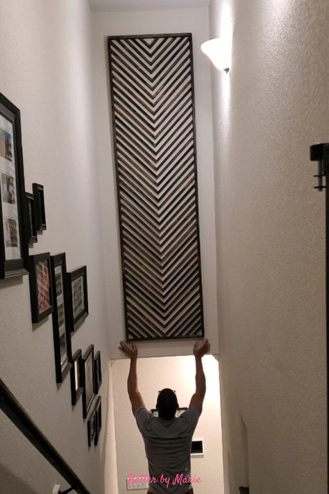 Wooden DIY artwork with herringbone pattern Bottom Stair Wall Decor, Stairwell Wall Ideas Basement, Black Wall Stairs, Tiled Staircase Wall, Diy Stair Wall Decor, Downstairs Wall Ideas, Unique Staircase Wall Decor, Stairwell Wall Art Ideas, Staircase Large Wall Decor