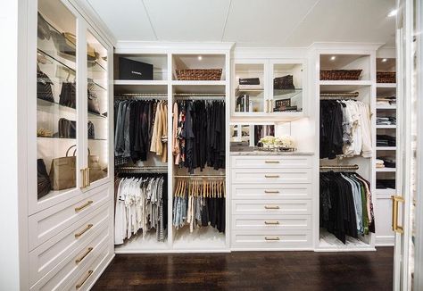 Large custom walk-in closet features white cabinets with brass pulls, marble countertops and glass front cabinet doors. Transitional Closet, A Walk In Closet, Master Closet Design, Dresser In Closet, Dressing Room Closet, Walking Closet, Armoire Dressing, Dream Closet Design, Walk In Closet Design