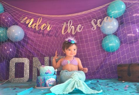 My daughter on her first birthday. Mermaid themed cake smash Mermaid Birthday Smash Cake, Oneder The Sea 1st Birthday Photoshoot, Mermaid First Birthday Party Decoration, Mermaid Smash Cake One Year Old, Little Mermaid First Birthday Party, Little Mermaid 1st Birthday Party, Mermaid 1st Birthday Party, Mermaid Birthday Party Decorations, Mermaid Theme Birthday Party