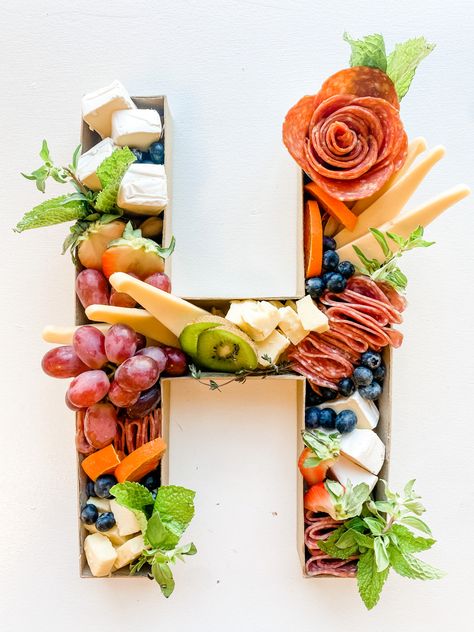 Cardboard Letter stuffed with Charcuterie and cheese. Charcuterie Letter Boxes Wedding, Letter Fruit Charcuterie Board, Charcuterie Letters Wedding, Charcuterie Board In Letters, Grand Opening Party Ideas, Charcuterie In Numbers, Grand Opening Party, Snack Board, Charcuterie Inspiration