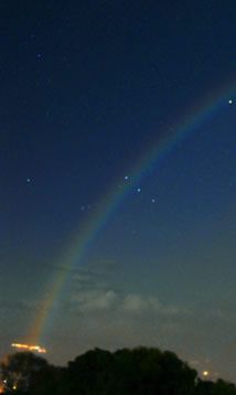 Moonbow and Venus imaged by Rob Ratkowski (photography) in May 2004.    Moonbows are very rare. The moon must be bright and not too high, the sky must be dark else the faint bow will not be visible and there must be rain in the direction opposite the moon.   Orion was setting when Rob took this spectacular image, Venus is the bright object inside the bow. Mars is above it to the left and Saturn is above Mars and outside the primary. Capella is the bright star to the right (north) of Venus. Lunar Rainbow, Venus Images, God's Promise, Black Rainbow, Moon Night, Bright Star, No Rain, Love Rainbow, Clear Sky