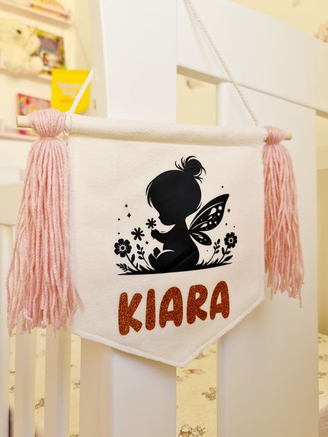 Enhance your child's room with our name banner. Made of quality felt, it adds warmth and personality to any space. Perfect for nurseries and playrooms, this banner is a unique and charming addition to your child's decor. Personalise their space with style and quality. Choose your preferred font(and colour) from the photos and add tassels of your choice.  Felt banner size is approximately 22cm x 25cm and comes with 2 wooden beads and tassels of your choice which are removable if you choose not to Fairy Banner, Jurassic Park Birthday, Park Birthday, Banner Size, Fairy Images, Felt Banner, Room Baby, Baby Banners, Name Banner