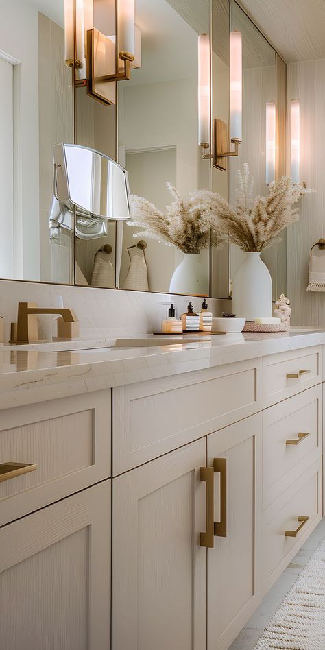 The bathroom has light-colored tiles that brighten the space. Beige Cabinets Bathroom, Bathroom Ideas Neutral Colors, White Cabinets Bathroom, White And Tan Bathroom, Cream Bathroom Vanity, Toilet Classic, Tan Bathroom, Colored Tiles, Tranquil Bathroom