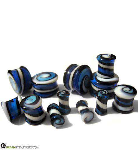 Blue, black, and white combine into a swirling design upon these plugs.The double flare plugs are all unique due to the nature of the glass they’re made of, but we’ll be sure to provide you with a matching pair since they’re sold in pairs.Get your Blue Spiral Design Glass Plugs in any of the following sizes: 2 gauge (6mm), 0 gauge (8mm), 00 gauge (10mm), 7/16 inch (11mm), 1/2 inch (12mm), 9/16 inch (14mm), 5/8 inch (16mm), and 3/4 inch (19mm). Pretty Plugs, Gauges Piercing, Tapers And Plugs, Small Gauges, 00 Gauge, Ear Gauges Plugs, Blue Spiral, Gold Body Jewellery, Fake Plugs