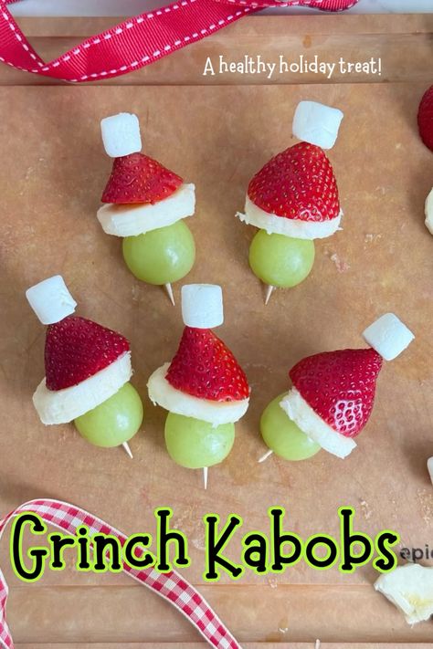 Its that time of year again where we can enjoy Christmas fruit skewers, also known as grinch kabobs! This magical holiday snack is healthy and can be customized to your own liking. These Christmas fruit on a stick with a marshmallow resembles the Grinch! This Grinch skewers recipe is perfect for Christmas parties or holiday get-togethers where you need a quick and easy snack. They are the perfect healthy. Treat for kids around the holidays. This is a nut free and egg free recipe. Grinch Fruit, Grinch Fruit Kabobs, Grinch Kabobs, Healthy Christmas Snacks, Christmas Party Snacks, Healthy Holiday Treats, Decorações Com Comidas, Fruit Kabobs, Christmas Fruit