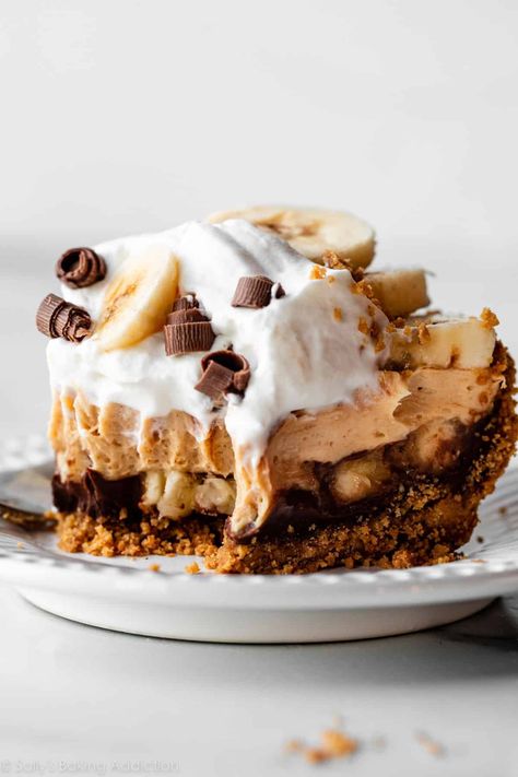 Peanut butter banana cream pie is a deliciously indulgent make ahead dessert! Enjoy a crisp Nutter Butter cookie crumb crust, rich chocolate ganache, sweet banana slices, creamy peanut butter mousse, and fluffy whipped cream on top. Pie recipe on sallysbakingaddiction.com Banana Peanut Butter Pie, Peanut Butter Creme Pie, Banana Caramel Pecan Pie, No Bake Banana Caramel Pecan Pie, Peanut Butter Banana Cream Pie, Reese’s Peanut Butter Pie No Bake, Cookie Crumb Crust, Peanut Butter Pie Filling, Peanut Pie