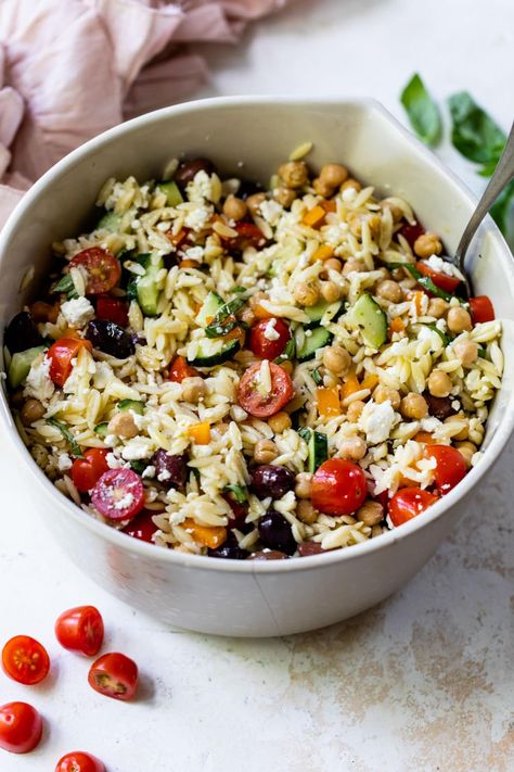 This Greek-inspired orzo pasta salad recipe is loaded with Mediterranean flavor thanks to the feta, olives, chickpeas, and basil. Delish! Greek Orzo Pasta Salad Recipe, Greek Orzo Pasta Salad, Greek Orzo Pasta, Summer Bbq Menu, Orzo Pasta Salad Recipe, Rice Salads, Greek Orzo, Feta Pasta Salad, Potato Salad Healthy