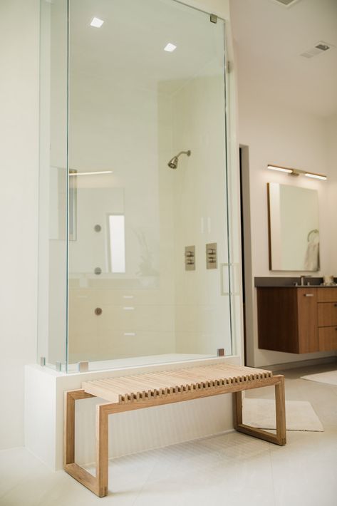 In this modern bathroom, a wooden shower bench was a necessity! It ties in the wood from the bathroom vanities and provides some warmth to the light, bright shower. What a wonderful addition for the perfect spa-like experience! Glass Shower Walls, Wooden Shower Bench, Glass Shower Wall, Home Spa Room, Chrome Fixtures, Shower Walls, Shower Bench, Freestanding Bathtub, Spa Room