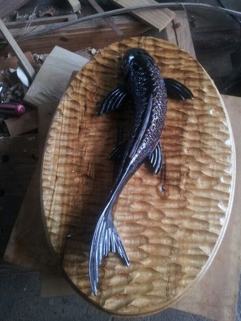 Black koi carved in mahogany and charred on a textured cypre  back. Koi Fish Wood Carving, Koi Sculpture, Fish Wood Carving, Cutlery Art, Geometric Sculpture, Dremel Wood Carving, Wood Fish, Clay Wall Art, Chip Carving