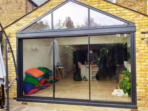 A beautiful gable roof with shaped glass split into 3 sections, our 3 panel 20mm virtually frameless sliding doors symmetrical design cladding done by others. Our made to order slim-line sliders have a 4 week lead time from chosen specification and a site measure! #frameless #framelessglass #slidingdoors #patiodoors #gableroof #structuralglass #renovation #myrenovation #homeimprovement #homedesign #designandbuild #kitchenextension #kitchendesign #bespokedesign Contemporary Door Design, Rear Extension Ideas, Kitchen Patio Doors, Modern Patio Doors, Gable Window, Bungalow Extensions, Sliding Doors Exterior, Garden Room Extensions, House Extension Plans