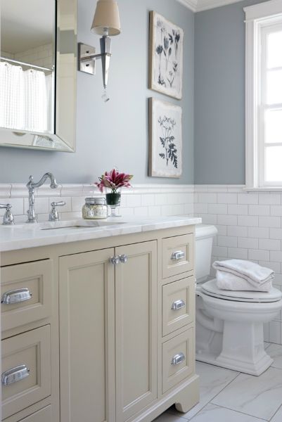 Cream and blue bathroom features upper walls painted blue and lower walls clad in white subway tiles lined with a cream washstand adorned with polished nickel cup pulls topped with white marble under a beveled mirror. Cream Bathroom, Subway Tiles Bathroom, Bathroom Color Schemes, Bathroom Images, Transitional Bathroom, Bathroom Color, Subway Tiles, Boho Bathroom, Trendy Bathroom