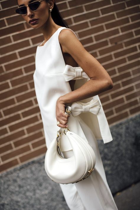 Luxury handbags like this white Fendi Fendigraphy bag are cheaper in some countries than others, thanks to multiple reasons like the VAT refund system available for tourists. If you're planning a trip down under, make sure to check out if Australia offers cheaper pricing than your home country in this article! | © Image of all white street style outfit via Launchmetrics Spotlight All White Street Style, Milano Street Style, White Street Style, Beige Crewneck, Trip To Australia, Classy Fall Outfits, Louis Vuitton Multi Pochette, Luxury Luggage, Style Inspiration Casual