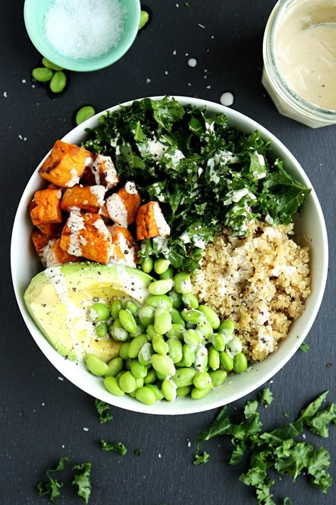 Kale Quinoa Sweet Potato Buddha Bowl Recipe || Made with chopped fresh kale, roasted sweet potatoes, quinoa, avocado, and edamame, and topped with a creamy tahini dressing. #mondaysundaykitchen #buddhabowlrecipes #buddhabowl #besthealthybowls #healthysaladrecipes #sweetpotatobuddhabowl #quinoabuddhabowl #kale Sweet Potato Buddha Bowl, Potato Buddha Bowl, Buddha Bowl Recipe, Kale Quinoa, Quinoa Sweet Potato, Buddha Bowls Recipe, Healthy Bowl, Kale Recipes, Healthy Bowls