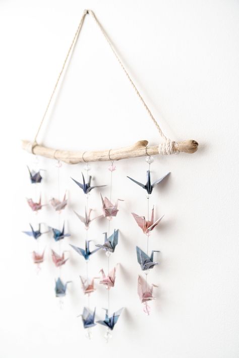 Origami cranes hang from driftwood #homedecorideas handmade #origamicrane #decor Origami Crane Hanging Diy, Paper Crane Crafts, Paper Crane Wall Art, Origami Display Ideas, Paper Crane Decoration, Paper Crane Chandelier, Hanging Origami Cranes, Origami Crane Hanging, Origami Crane Wall Art