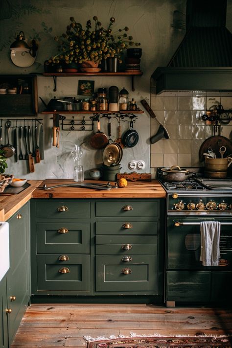 Cozy vintage kitchen featuring sage green cabinets, hardwood floors, and eclectic decor. Perfect blend of rustic charm and functionality. Fall Inspired Kitchen, Rustic Dark Green Kitchen, Forest Cottage Kitchen, Sage Green Kitchen Cabinets Color Scheme, Kitchen Green Ideas, Dark Green And Copper Kitchen, Light Academia Aesthetic Kitchen, Green Kitchen Dark Wood, Green 70s Kitchen