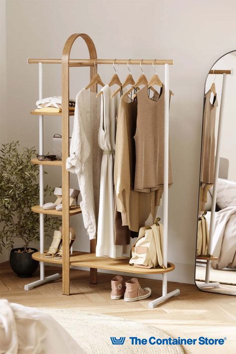 This space-saving clothing rack creates beautiful wardrobe storage wherever needed. With four shelves and a steel garment rod, the Umbra Bellwood Garment Rack provides space for clothes, handbags, accessories, boots and shoes. It's durably built to hold even heavy items. Curved bentwood accents give this garment rack the look of furniture, blending easily in a bedroom, guest room, laundry room, entryway or sewing room. Clothes Rail With Shelves, Neutral Bedroom Furniture, Gender Neutral Bedrooms, Standing Closet, Space Saving Shelves, Nursery Furniture Collections, Boys Bedroom Furniture, Free Standing Closet, Design Online Shop