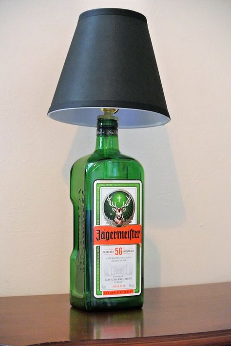 Give a brilliant gift! Beautiful glass liquor bottle lamps make for stunning gifts! Bottle decor is very popular right now and these beautiful and trendy glass bottle lamps will blow them away. Jagermeister German liqueur bottle lamp! GREAT GIFT! Add life to any room and make Glass Bottle Lamp, Liquor Bottle Lamp, Glass Liquor Bottles, Man Cave Lighting, Liquor Bottle Crafts, Black Lamp, Wood Projects That Sell, Candle Cover, Alcohol Bottles