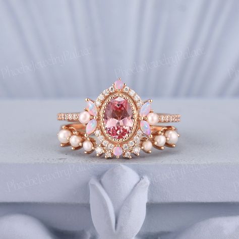 Vintage Oval Pink Sapphire Engagement Ring Set Unique Pearl Opal Cluster Pinky Wedding Rings for Women Anniversary Gift for Her Personalized PRODUCT SUMMARY Metal Type: yellow, white or rose solid 10k, 14K or 18k gold. Size: All sizes are available, contact me if they do not contain the size you want in the drop-down menu. ☪☪Engagement ring ⚜Center Stone - Lab Grown Peach Pink Sapphire Cut - Oval Size - 5x7mm ⚜Side Stone - Natural Pinky Opal & Moissanite Cut - Round & Marquise cut Weight -0.396c Pink Pearl Wedding Ring, Pink Sapphire Rings, Engagement Rings Colorful, Engagement Rings With Color, Wedding Rings Colored Stones, Pink Wedding Rings Sets, Kunzite Engagement Ring, Unique Rings Engagement, Rose Wedding Ring