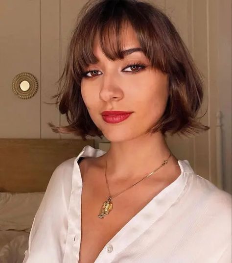 a beautiful brunette chin length bob with wispy bangs and waves is a stylish and eye catching idea Brunette Bob With Bangs, Ear Length Bob, Bob With Wispy Bangs, Short Bob Haircuts With Bangs, Messy Blonde Bob, Bob Haircuts With Layers, Short Bob With Bangs, Haircuts With Layers, Bob Haircuts With Bangs