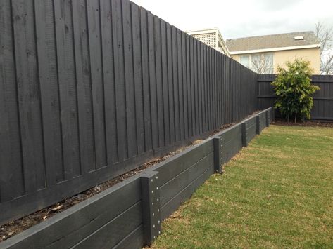 Retaining Walls Geelong Timber & Precast Concrete - Kardinia Landscape Constructions Black Wood Retaining Wall, Painted Timber Retaining Wall, Retaining Wall Side Of House, Modern Farmhouse Retaining Wall, Concrete Retaining Wall Makeover, Retaining Wall Under Fence, Black Retaining Wall Garden, Black Retaining Wall, Fence Retaining Wall