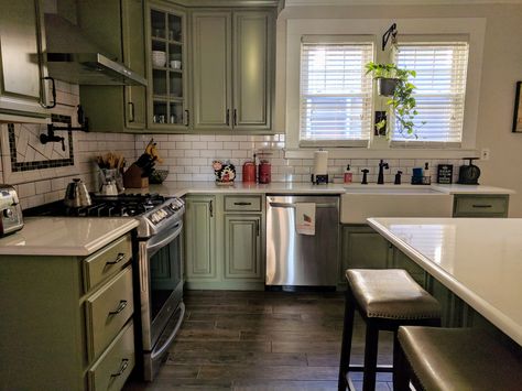 American Foursquare kitchen. Sage green cabinets, white subway tile, dark grout, wood tile floor, quartz countertop. Sage Kitchen Dark Floor, Sage Green Kitchen Dark Floor, Sage Green Kitchen Cabinets Dark Floor, Sage Green Cabinets White Countertops, Green Kitchen Cabinets With Dark Wood Floors, Green Cabinets Dark Floor, Kitchen Cabinets Dark Wood, Green And Wood Kitchen, Sage Green Cabinets