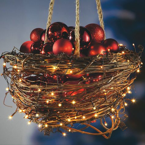 6. The grapes of wreath: Reconfigure woodsy grapevine wreaths into a bowl-like basket that you can fill with shimmering battery-powered twinkle lights and glimmering ornaments. This rustic grapevine basket, created by Jo-Ann Fabric and Craft Stores, is perfect for hanging from a hook on your front porch or in the corner of a room that needs a seasonal boost. Supplies, instructions: � Two 12-inch grapevine wreaths � 1 package brown cloth-covered stem wire, 22-gauge � 1 roll natural jute � 3 ... Island Forest, Christmas Hanging Baskets, Christmas Nuts, Diy Christmas Lights, Christmas Island, Beautiful Christmas Decorations, Christmas Porch Decor, Christmas Decorations Diy Outdoor, Christmas Porch