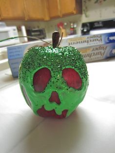 Snow White Poisoned Apple -fake apple,  at Michaels  -green fabric paint, at Michaels (definitely could have gone with the smaller, cheaper bottle)  -green glitter, not sure of the cost ’cause I found this for freeeeee  -twine, also already had this  -paintbrush  (not pictured)  -felt pen  -Elmer’s glue (probably don’t need this, see step 4)  -paper towels  -small dish  -tid bit of water Snow White Poison Apple, Diy Snow, Tema Disney, Snow White Birthday, Snow White Party, Poison Apple, Poison Apples, Snow White And The Seven Dwarfs, Disney Crafts