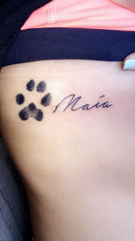 Tattoo on my ribs/side of my dog Maia's paw print and her name Paw Print Rib Tattoo, Paw Print Tattoo With Letter, Paw Print Tattoo With Name, Paw With Letter Tattoo, Paw Print Tattoo On Ribs, Dog Paw Print Tattoo With Name, Dog Name And Paw Print Tattoo, Dog Paw Print With Name Tattoo, Cat Paw Print Tattoo With Name