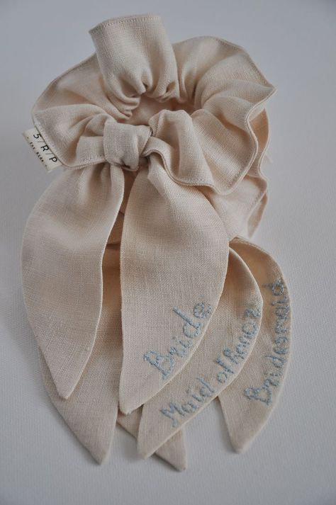 Linen scrunchies with long bows are sustainable hair accessories with hand embroidery or without it. They are perfect for finishing and styling hair in a ponytail or messy bun. It’s a great wedding hair accessory: bride accessories, bridesmaid accessory, bachelor party accessory,... Click through to see other colors or find other hair accessories! #weddingaccessories #brideaccessories #embroideredhairaccessories #hairaccessories #scrunchies #scrunchieshairstyles #girlstyle #hairstyles Schruncies Aesthetic, Embroidery Scrunchie, Wedding Scrunchie, Linen Accessories, Lace Hair Accessories, Heirloom Wedding, Girl With Brown Hair, Styling Hair, Bridesmaid Accessories