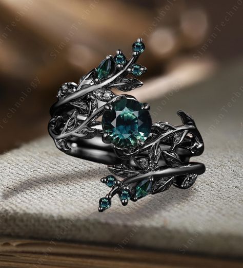 Gothic Art deco Teal Sapphire Engagement Ring Set Vintage Black Gold Leaf Matching Stacking Wedding Band Unique Twig Bridal Promise Gift Set Applicable scene: anniversary, birthday party, wedding, engagement, gift ■ Handmade, high-quality item! ■ Material: S925 Sliver SOLID 14K/18K BLACK GOLD (can be made in white/rose/yellow gold) Engagement ring ■ Center stone: Teal Sapphire ■ Size/Weight: 6.5mm round ■ Side stones: Teal Sapphire/Moissanite ■ Total weight: NONE (High Quality) ■ Cut - VG ■ Colo Gothic Sapphire Jewelry, Engagement Rings Sets Teal And Black, Black Gothic Engagement Ring, Black Wedding Ring Sets, Gothic Art Deco, Art Masters Jewelry, Teal Sapphire Engagement Ring, Gothic Engagement Ring, Sapphire Engagement Ring Set