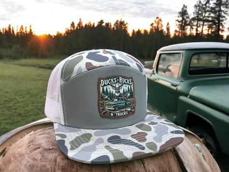 Upgrade your style with the Ducks Bucks N' Trucks Leatherette and DTF Patch on one of our new hats from Lost Hat. Co. - SA7AGE 7 Panel Flat Bill Trucker Hat. This expertly crafted hat boasts a sleek, flat bill design and a durable 7-panel construction for a comfortable and stylish fit. Wear it with any outfit for a touch of rugged sophistication. Bill Design, Newborn Layette, Country Hats, Deer Pictures, Laser Engraved Leather, Plaid Dog Bandana, Pretty Hats, Ranch Wear, Cute Country Outfits