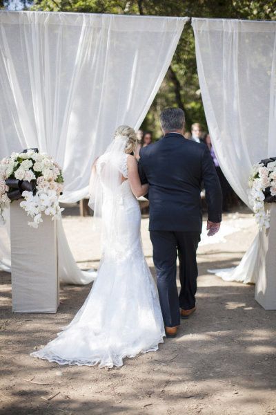 Arrive in style and make a grand entrance at your outdoor ceremony with one of these 10 ideas: Romantic sheer curtains are a great way to create suspense. Additionally, a similar set of curtains can be set up as a ceremony backdrop to create symmetry Curtain Entrance, Outdoor Wedding Entrance, Wedding Ceremony Backdrop Outdoor, Curtain Doorway, Ceremony Entrance, Altar Ideas, Outdoor Entrance, Entrance Ideas, Diy Wedding Backdrop