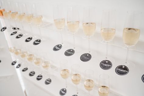 A champagne wall used as a seating chart for this wedding in July. The champagne flutes have the guests names and table numbers on the tag around the bottom. Antiquity Photography #wedding #weddings #julywedding #champagnewall #barnwedding #cocktailhour #rusticwedding #blackandwhitewedding Champagne Wall, July Wedding, Champagne Flutes, Seating Chart, Seating Charts, Flutes, Cocktail Hour, Table Numbers, Photography Wedding