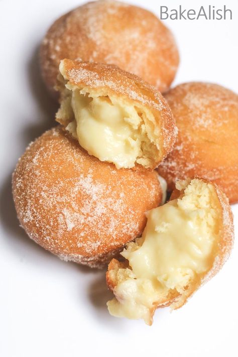 These Vanilla Custard Filled Donuts are also called Bomboloni. A soft and fluffy doughnut recipe with pastry cream filling on the inside Custard Filled Donuts Recipe, Maple Cream Filled Doughnut, Soft Custard Rolls, Cream For Donut Filling, Bakery Doughnut Recipe, Lemon Filled Donuts Recipe, Custard Doughnut Recipe, Filling For Donuts Recipes For, Custard Filled Desserts