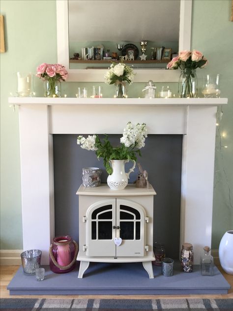 Chalk painted fire surround and marble.....with beautiful flowers and fairy lights. Fire Surround Ideas Flat Wall, Cream Log Burner Fireplace, Fire Surround Ideas, Painted Fire Surround, Electric Fireplace Victorian, Conservatory Inspiration, Marble Fire Surround With Log Burner, Victorian Fire Surround With Log Burner, Tiled Fireplaces