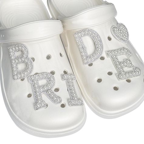 PRICES MAY VARY. Material: Bride Shoe Charms adopt quality made with durable Diamond Pearl materials, enough Beautiful decoration that can be used easily. That will give you that extra oomph your outfit needs.( Slippers not included ) Unique Design: The white Slippers Accessories is are adorned with bling diamond Pearl lettering, This not only a good decoration at the bachelor party but also an excellent Photo props for you to take pictures, once you put them on, you'll instantly become the cent Bride Crocs, Wedding Crocs, Bride Shoe, Aesthetic Shoe, Ideal Aesthetic, Shoes Charms, Shoe Ornaments, White Slippers, Pearl Shoes