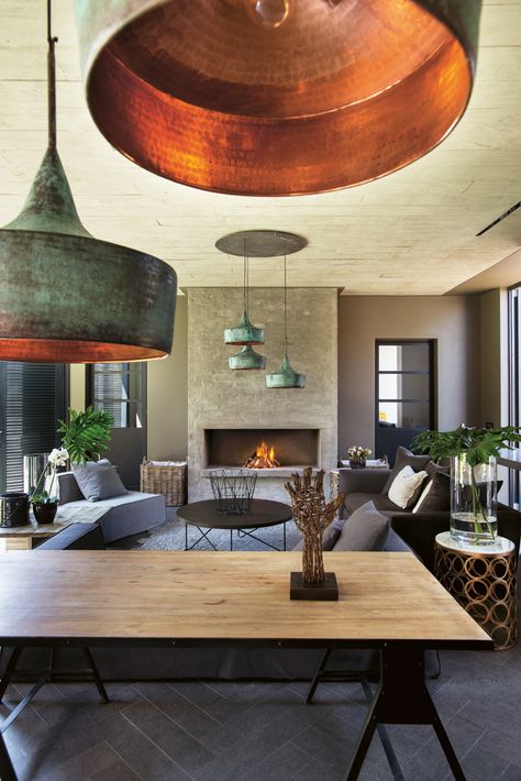 The rustic copper light fittings in the indoor patio hang off a concrete ceiling where Joe used old floorboards as a shutter board, leaving a timber imprint. Old Floorboards, Copper Light Fixture, Copper Interior, Copper Light, Concrete Ceiling, Concrete Lamp, Hotel Room Design, Homeward Bound, Restaurant Lighting