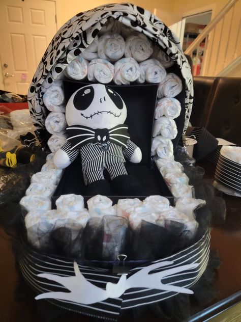 Bassinet made out of diapers with jack skellington themed decor Dollar Tree Nightmare Before Christmas, Nightmare Before Christmas Gender Reveal Party, Nightmare Before Christmas Gift Basket, Night Before Christmas Baby Shower Gift Basket, Nightmare Before Christmas Gender Reveal Ideas, Jack Or Sally Gender Reveal, Jack And Sally Gender Reveal Ideas, Nightmare Before Christmas Diaper Cake, Night Before Christmas Baby Shower Ideas