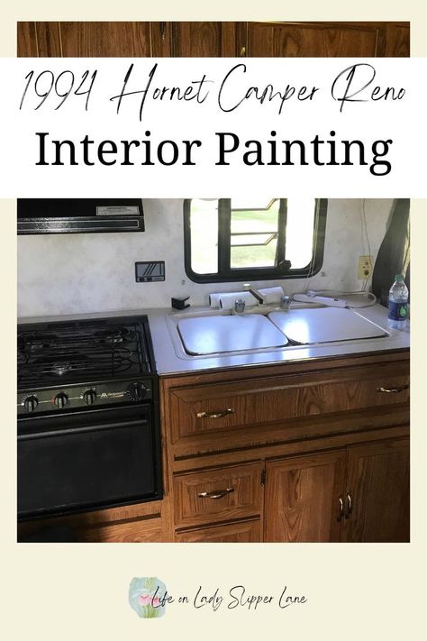 wooden camper cabinets with covered sink and black stove/oven Camper Renovation Interior, Camper Redo Ideas, Camper Renovation On A Budget, Camper Remodel On A Budget, Diy Camper Renovation, Camper Redo, Camper Diy, Camper Reno, Old Campers