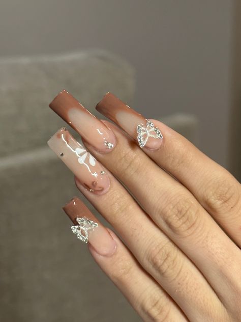 @ xnailsbyariana on instagram #brownnails #fallnails #butterflynails #blingnails #brownfrenchtip #flowernails #longnails #acrylicnails #acrylicnailssquare #squarenails brown nails, brown nail inspo, fall nails, fall nail inspo, butterfly nails, butterfly nail inspo, brown french tip nails, flower nails, flower nail inspo, long acrylic nails, square acrylic nails Brown Nails With Butterflies, Fall Nails Inspo Square, Tan Nails Acrylic Design, Brown Hoco Nails, Pretty Nails Brown, Different Brown Nails, Fall Tapered Square Nails, Brown Spring Nails, Birthday Nails Brown