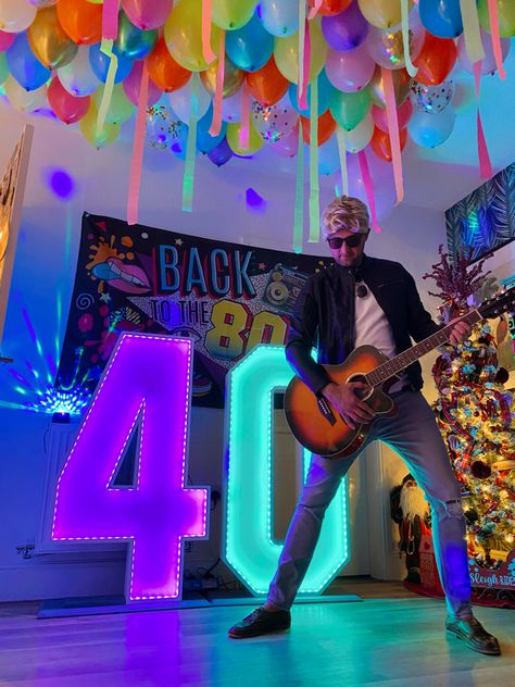 40th birthday 80s party. 80s party decor with balloon ceiling. #80sparty #80s #40thbirthday #balloondecor #balloons #balloonstyling 80s Party Decor, 80's Theme, Garage Party, Balloon Ceiling, Balloon Tower, 80s Theme Party, 80s Theme, 80s Party, 40th Birthday