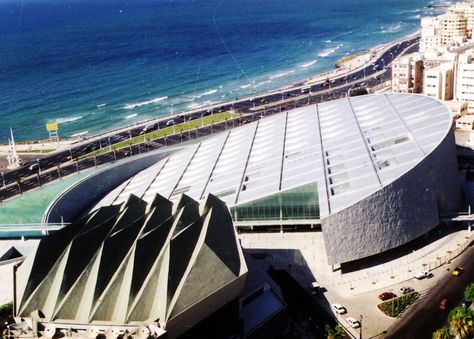 The Bibliotheca Alexandrina Today, as we continue our journey to libraries around the world, we stop at the Bibliotheca Alexandrina, located in Egypt off the shore of the Mediterranean Sea. More than just a library, the Bibliotheca Alexandrina institution is a major cultural center. The BA prides itself in being an arena for cultural pluralism, and has made it a core value in their effort to promote diversity and freedom of expression Bibliotheca Alexandrina, Beautiful Library, Freedom Of Expression, Alexandria Egypt, Black Sand Beach, Library Design, Cultural Center, Mediterranean Sea, Our Journey