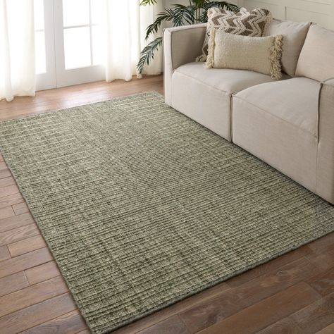 A classic handwoven construction with clean, contemporary appeal, the Amity collection brings interest and grounding texture to on-trend spaces. The Vidalia area rug features a heathered green hue with flecks of cream, brown, and beige. A ridged weave adds dimension and depth to any modern home. The fiber-dyed wool and durable PET blend of this collection lends the perfect accent to heavily trafficked areas of the home such as living rooms, halls, and entryways. Rug Pad Recommended: prevent bunc Contemporary Rugs Design, Solid Area Rugs, Jaipur Living, Living Room Green, Solid Rugs, Brown And Beige, Green Area Rugs, Burke Decor, Hand Tufted Rugs