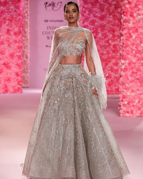 "Coralie" Cocktail Lehenga Powdery sage shimmer tulle structured lehenga accentuated with thread work and hand crystal beading, paired with bustier choli and draped tulle dupatta - highlight is the feather engulfed cuff on dupatta. Available at Delhi and Mumbai Store. Jewellery Partner: @shailjas_naturaldiamonds Shoe Partner: @venussteps Gift Partner: @smokelabofficial Celebration Partner: @cedarclubhouse Photography : @gesuseth @hyundaiindia @reliancebrandsitd @lotus_herbals #FDCI #Hyun... Cocktail Lehenga, Shimmer Lehenga, Reception Outfit, Royalty Aesthetic, Indian Bridal Fashion, Desi Fashion, Thread Work, Bridal Fashion, Bride Bridal