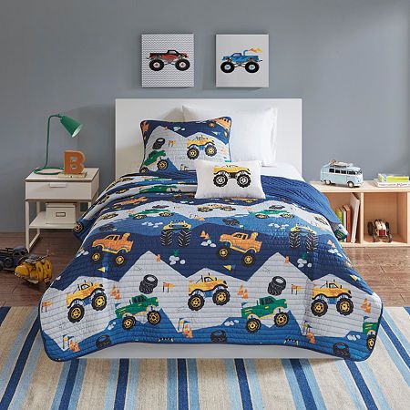 Cruise off to sleep with the Mi Zone Kids Gavin reversible Quilt Set. The fun and exciting Quilt and matching sham(s) feature a truck print motif in green and orange colors on an ultra-soft blue and gray base fabric. A solid blue reverse complements the top of the bed, while an oblong decorative pillow with hypoallergenic filling flaunts an appliqué truck on the face completing the Quilt Set. Prewashed to prevent shrinkage with cotton rich filling, this child's Quilt Set offers an adorable updat Grey Comforter, Blue Comforter Sets, Blue Comforter, Accent Colors For Gray, Twin Comforter, Queen Comforter Sets, Print Comforter, Bedding Stores, Coverlet Set