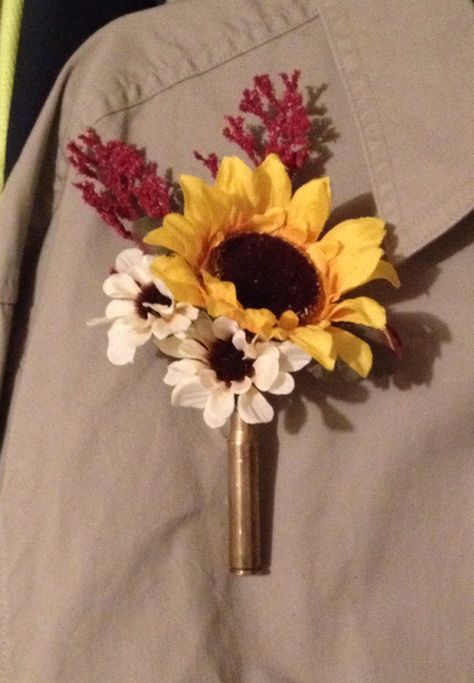 Boutonniere. 30 30 shell casing and sunflower. Mens Sunflower Boutineer, Shell Casing Boutonniere, Fishing Lure Boutonniere, Bullet Boutonniere, Boutineer Wedding, Diy Boutonniere, Shotgun Shell, Sunflower Wedding, Boutonniere