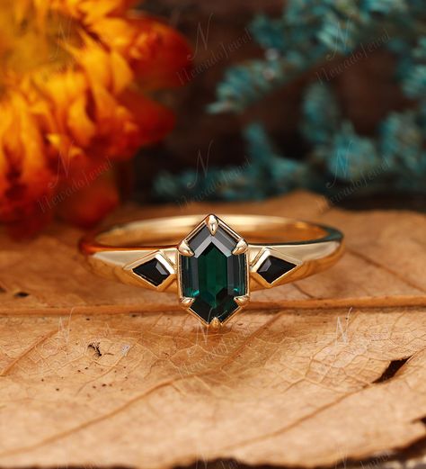 Tapered Band Ring, Long Hexagon Cut 1.1ct Emerald Engagement Ring, Black Onyx Side Stone Ring, 6 Prong Wedding Ring, May Birthstone Gift ----Ring Information----  Main Ring  Main Stone : * Lab Created Emerald * 5x9mm Long Hexagon Cut * Approx. gemstone weight: 1.10 carats * Color: Green - 5A * Clarity: VVS Side Stone:  * Natural Black Onyx * Kite Cut  * Approx weight: 0.22ctw Metal:  * Solid 10K/14K/18K yellow gold  (Can be 14K/18K white gold, yellow gold or rose gold, choose it in material option) Band Width(bottom): 1.50mm Band Thickness: 1.20mm SKU: NADR2782X-LH5x9mm Ring can be sized from 3-11, if you need other sizes, please contact us before hand. Metal can be made in 14 & 18k white/ yellow/ rose gold. Contact us for more materials. The gemstone can be replaced with amethyst, aquamar Black And Emerald Engagement Ring, Dark Emerald Ring, Nonbinary Engagement Ring, Spooky Engagement Ring, Portrait Cut Ring, Engagement Rings Green Stone, Black And Gold Engagement Ring, Band Wedding Rings Women, Alternative Stone Engagement Rings