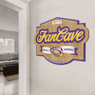 With this attention-grabbing wall display, visitors will make no mistake when they're entering the fan zone. Proudly feature your favorite team in a unique dimensional design that's sure to get compliments. And since it's perfect for your home, office, basement, den, or game room – ANY room can become your official Fan Cave. NCAA Fan Cave Sign: LSU Tigers | YouTheFan FCS Wall Décor in Brown / White | 12.5 H x 17 W x 0.25 D in | Wayfair | Home Decor Home Office Basement, Basement Den, Office Basement, Tiger Wall Decor, Football Door Hangers, Fan Cave, Accent Wall Decor, Floating Wall, Lsu Tigers